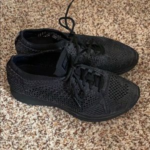 Women’s all black fly knit racers